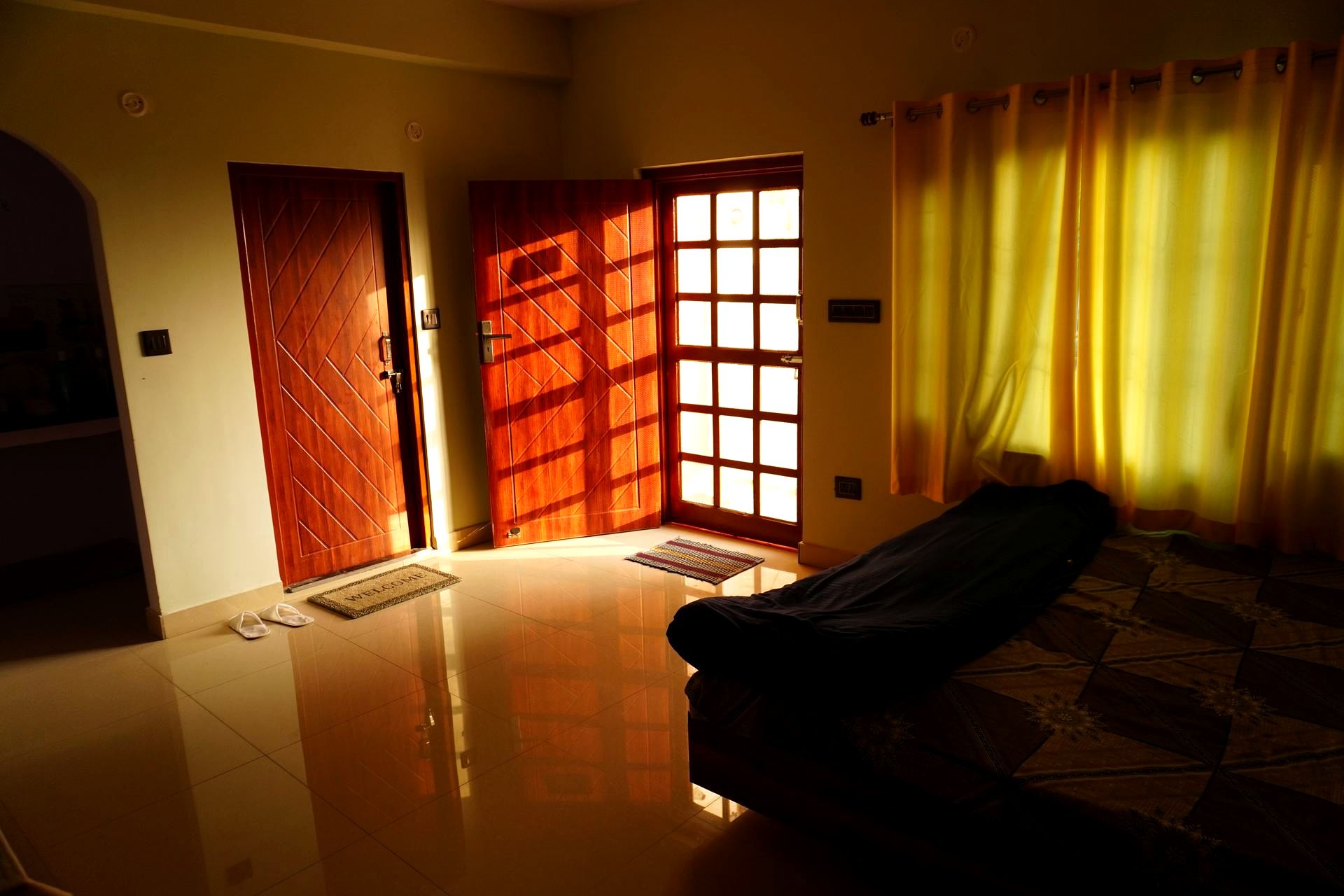 Open wooden doors at golden hour leading onto the terrace