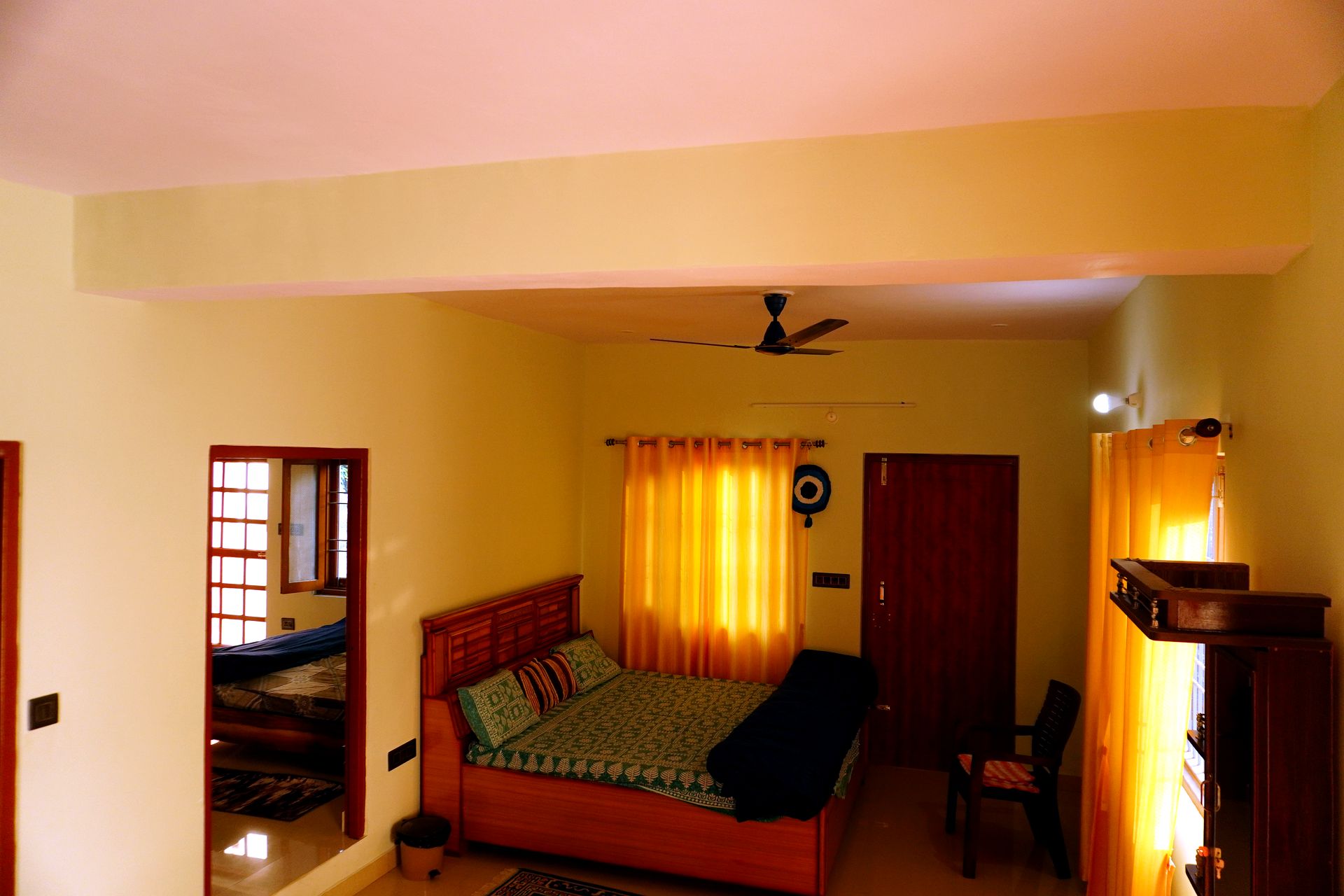 Bedroom with wooden headboard and horse painting above the bed